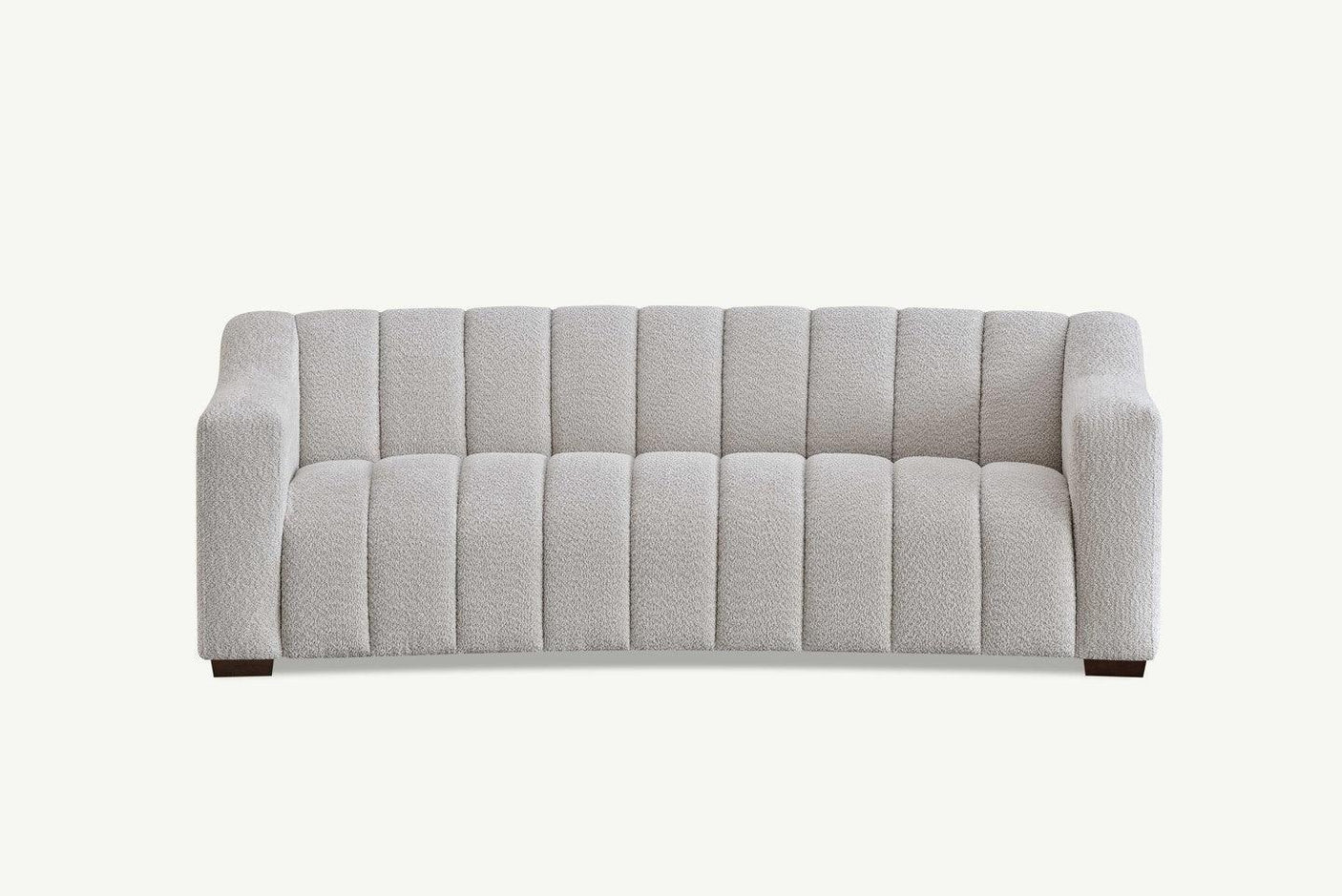 Light grey fabric sofa with channel tufting and low block arms, front view on white background