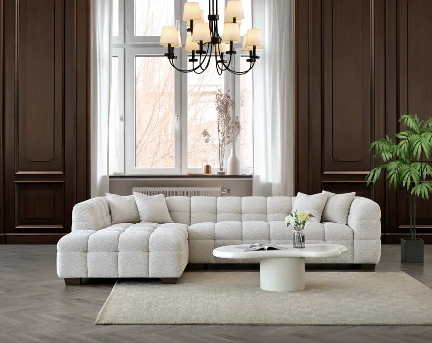 Modern cream fabric corner sofa with tufted cushions in elegant living room setting