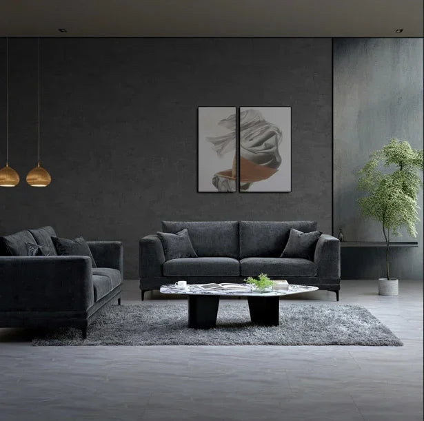 Dark grey velvet sofa set with cushions in modern living room, oval coffee table and rug