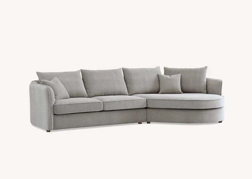 Light grey fabric corner sofa with chaise and scatter cushions on white background