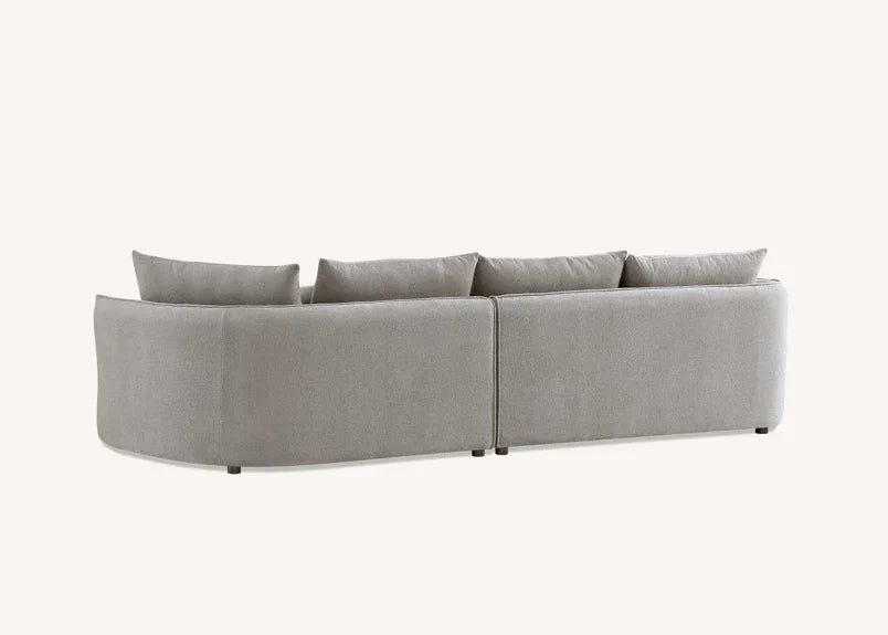 Back view of modern grey fabric corner sofa with low legs and five matching cushions