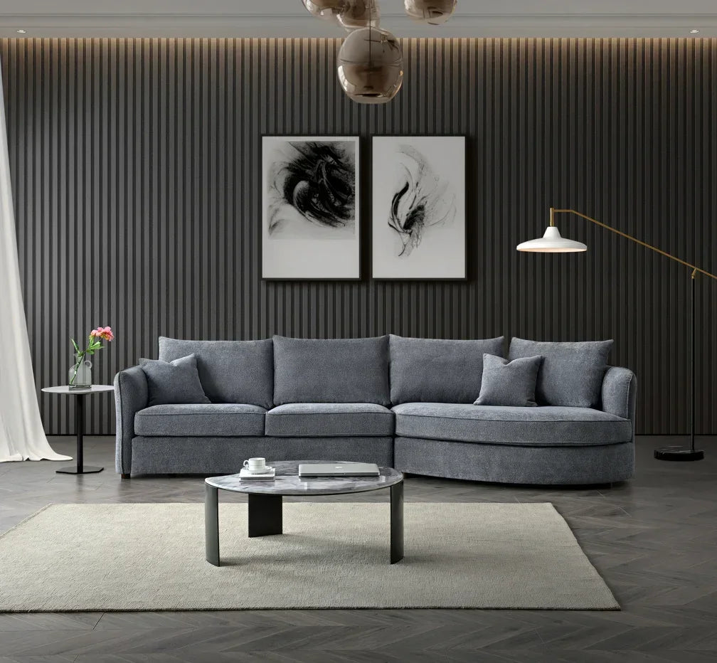 Grey corner sofa with cushions in modern living room featuring round coffee table
