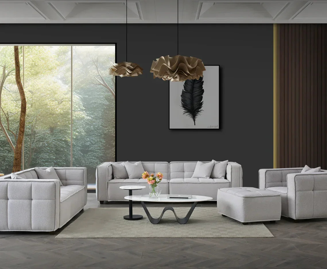 Modern grey fabric sofa set with matching ottoman and coffee table in a contemporary living room