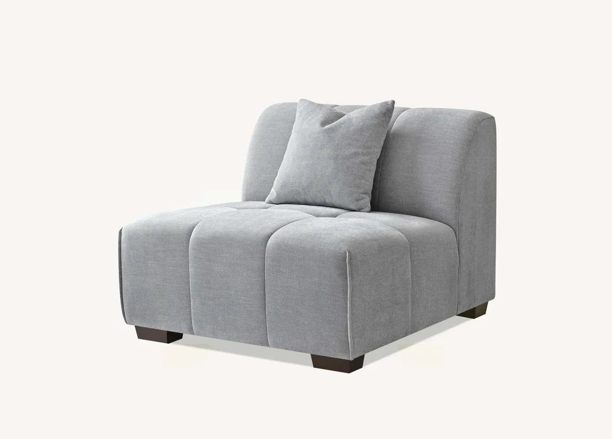 Light grey fabric armless sofa chair with cushion, tufted seat, and wooden legs
