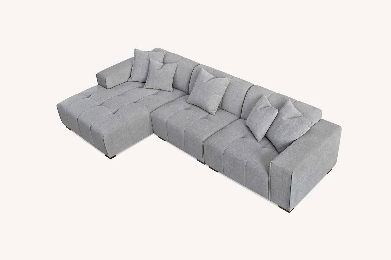 Light grey corner sofa with tufted upholstery and scatter back cushions, viewed from above