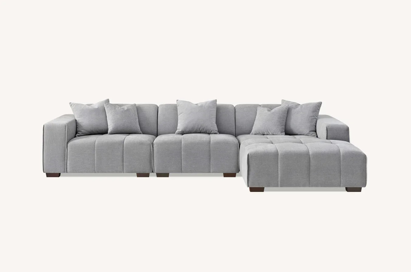 Light grey fabric corner sofa with chaise lounge and matching scatter cushions
