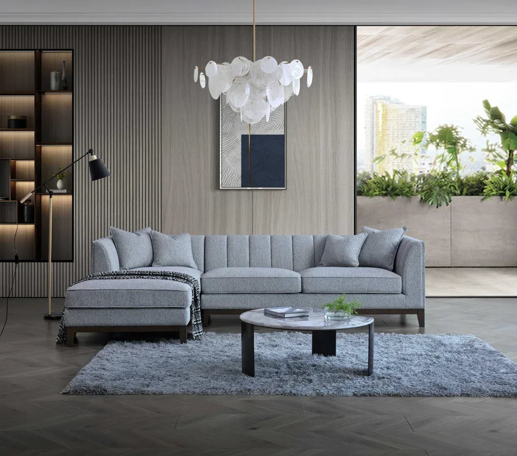 Light grey fabric corner sofa with chaise and cushions in modern living room