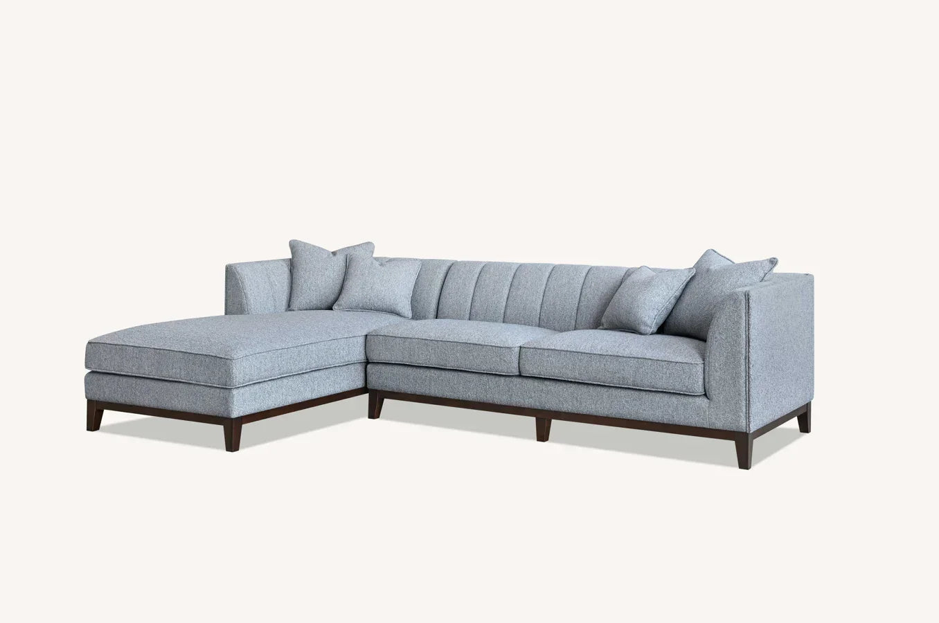Light grey corner sofa with chaise, tufted backrest and dark wood legs, includes scatter cushions