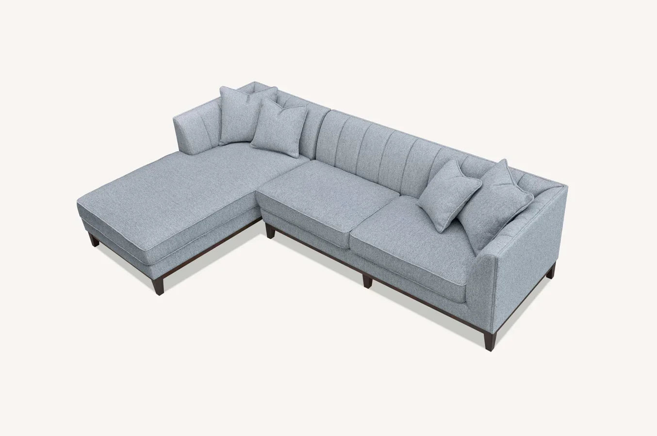Light grey fabric corner sofa with chaise and scatter cushions on wooden legs