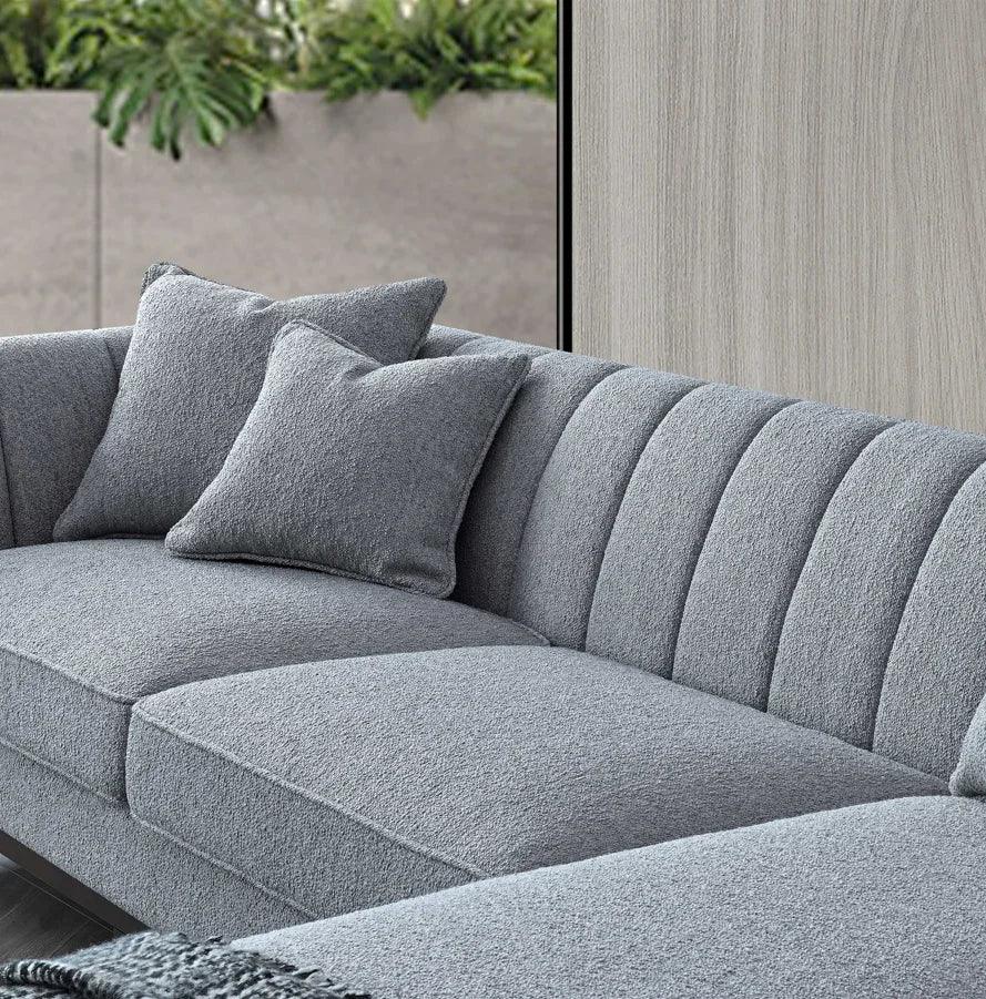 Modern grey fabric sofa with vertical channel tufting and two matching cushions