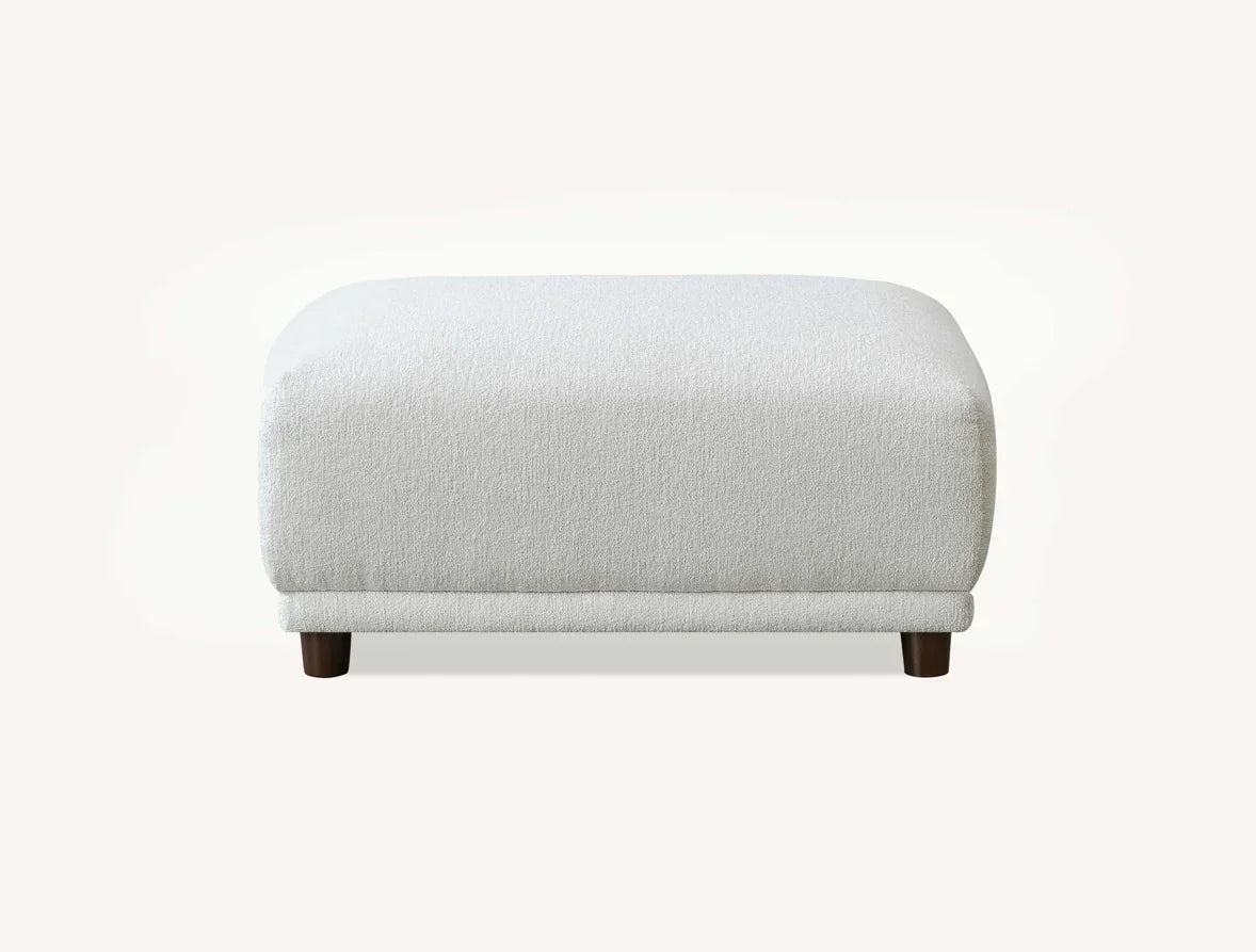 White fabric ottoman with dark wooden legs, front view against plain background