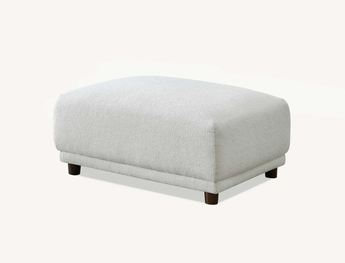 Light grey fabric ottoman with wooden legs on white background