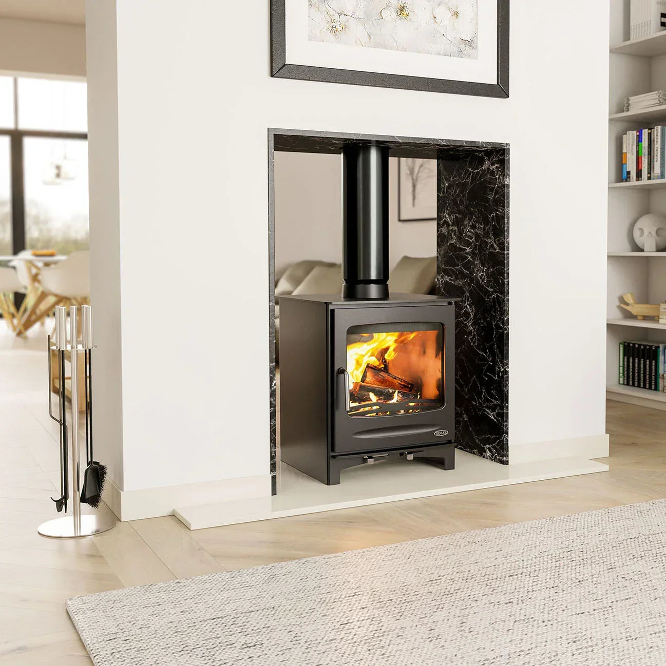 Black wood burning stove with firewood burning, set in marble fireplace, modern living room