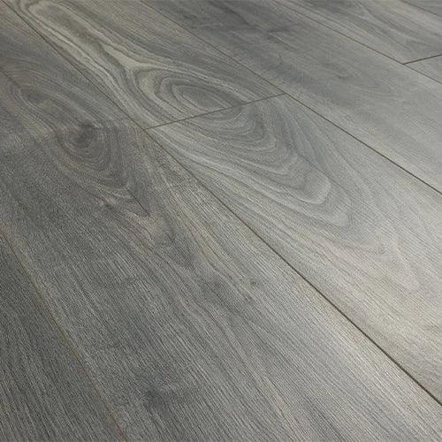Grey oak effect laminate flooring with wood grain texture and wide planks