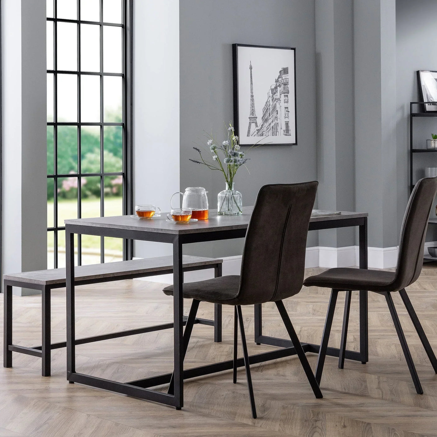 Staten dining table set with wooden bench and two brown chairs in modern dining room