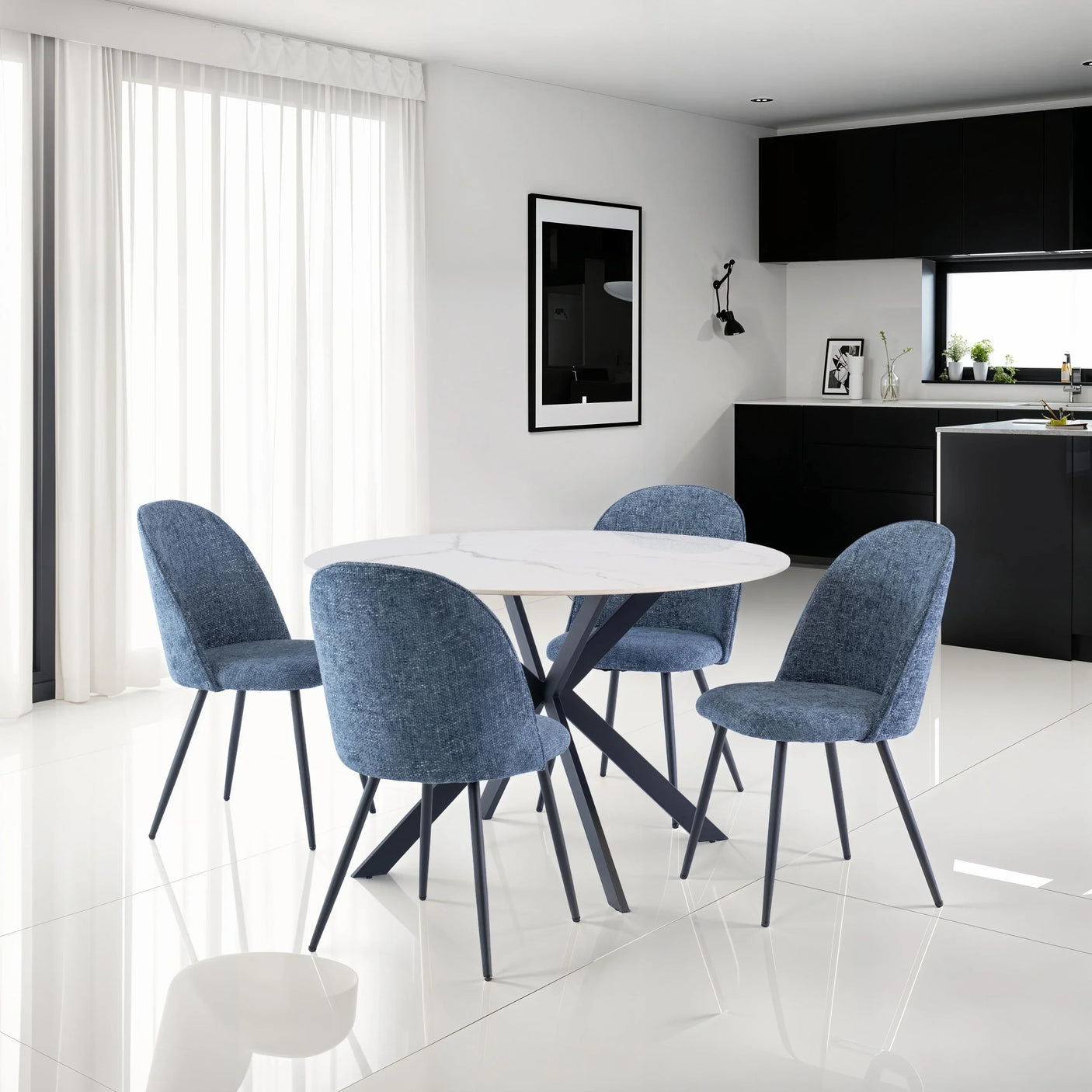 Round white marble dining table with blue upholstered chairs in modern kitchen