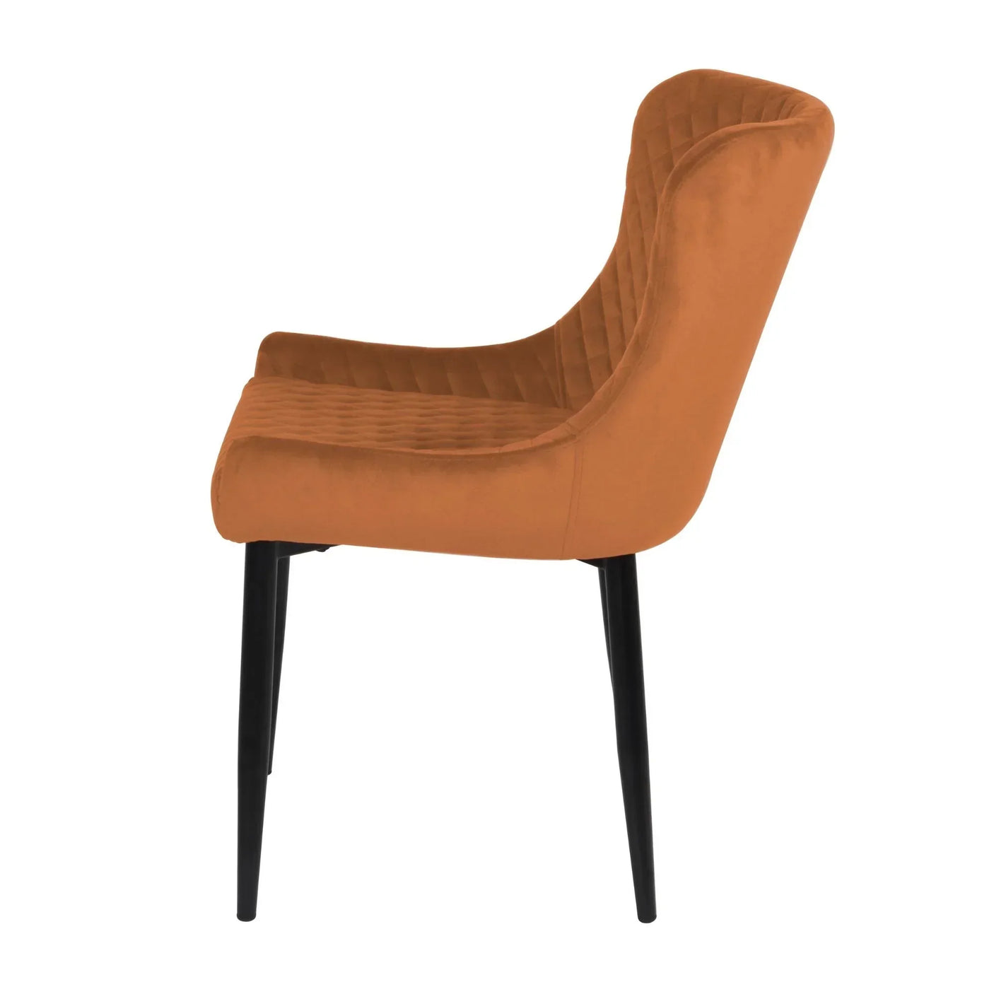Side view of an orange velvet dining chair with black metal legs and quilted seat detail