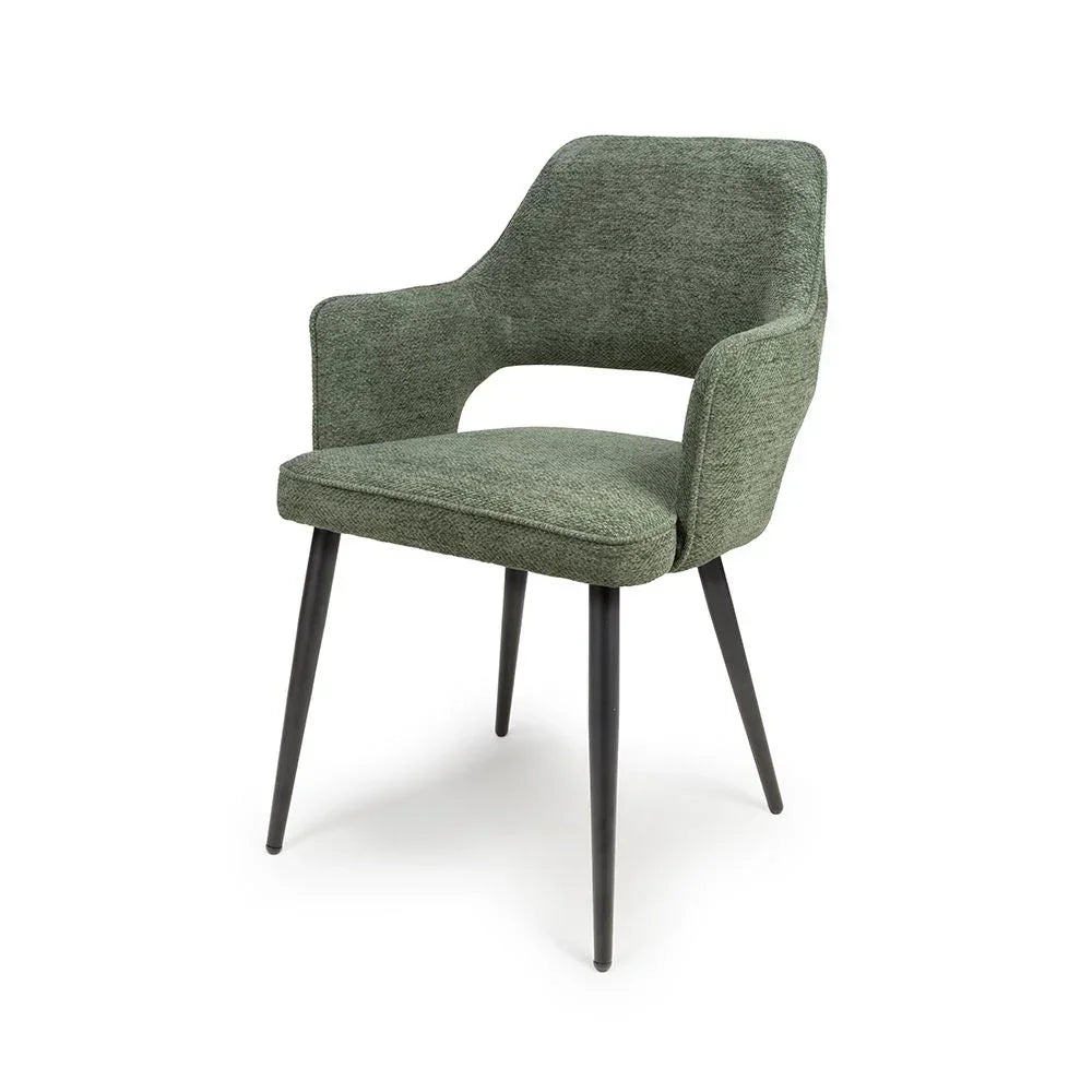 Green fabric dining chair with armrests and black metal legs, angled front view