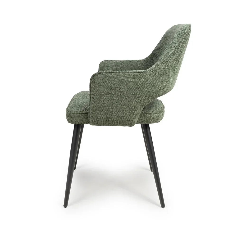 Green fabric dining chair with armrests and black tapered legs, side profile view