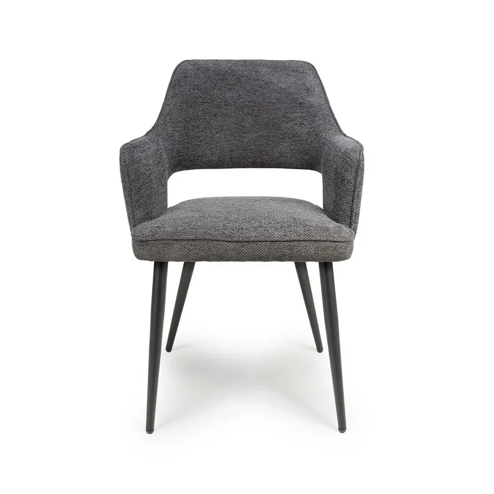 Grey fabric dining chair with curved backrest and black metal legs front view