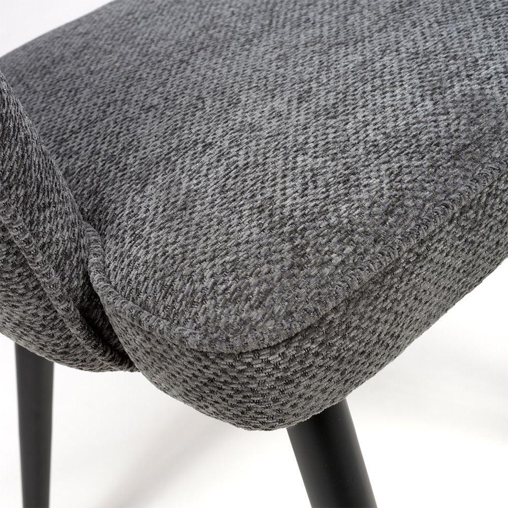 Close view of textured grey dining chair seat with black legs