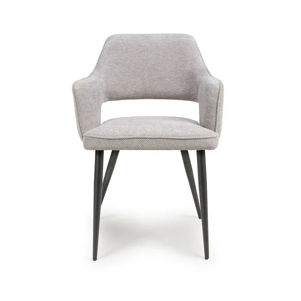 Light grey upholstered dining chair with metal legs and open backrest, front view