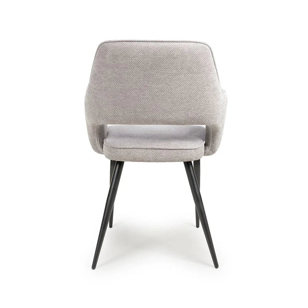 Light grey fabric dining chair with black metal legs, rear angle view