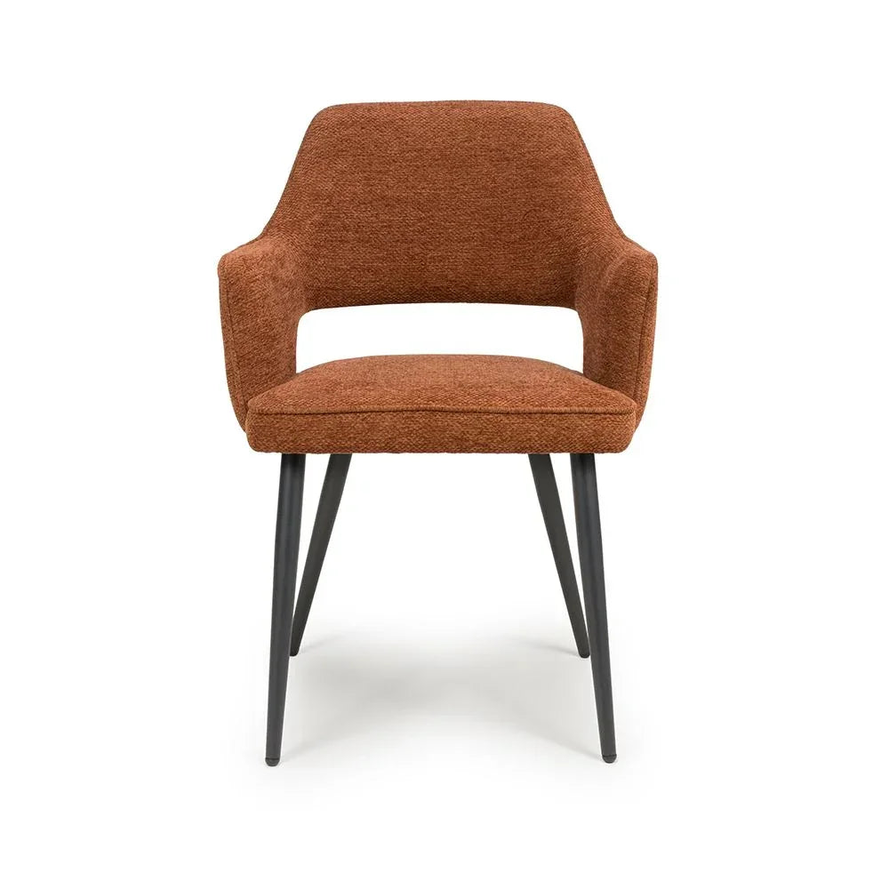 Rust fabric dining chair with padded seat and black metal legs, front view