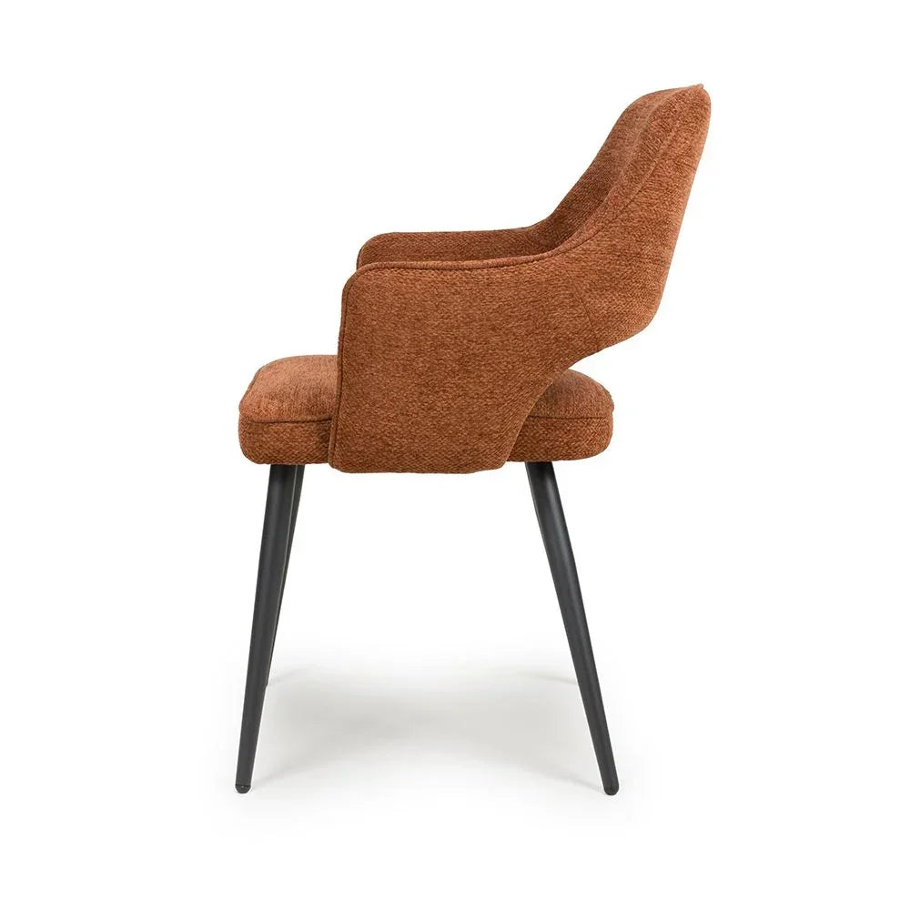 Brown fabric armchair with black metal legs, viewed from the side