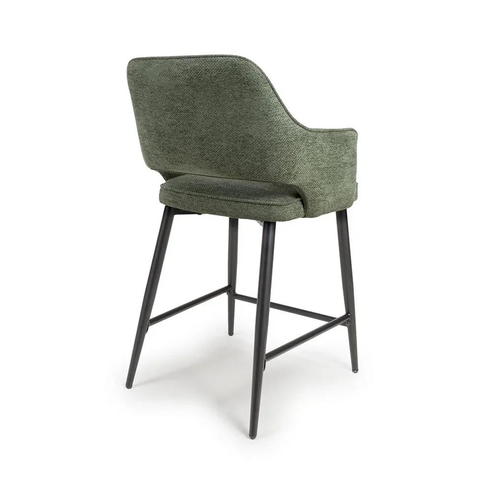 Green upholstered bar stool with black metal legs, rear view