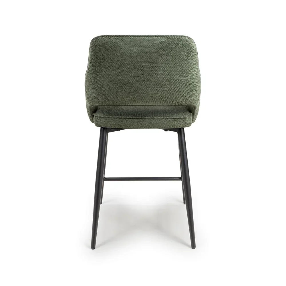 Green fabric dining chair with black metal legs, rear view on white background