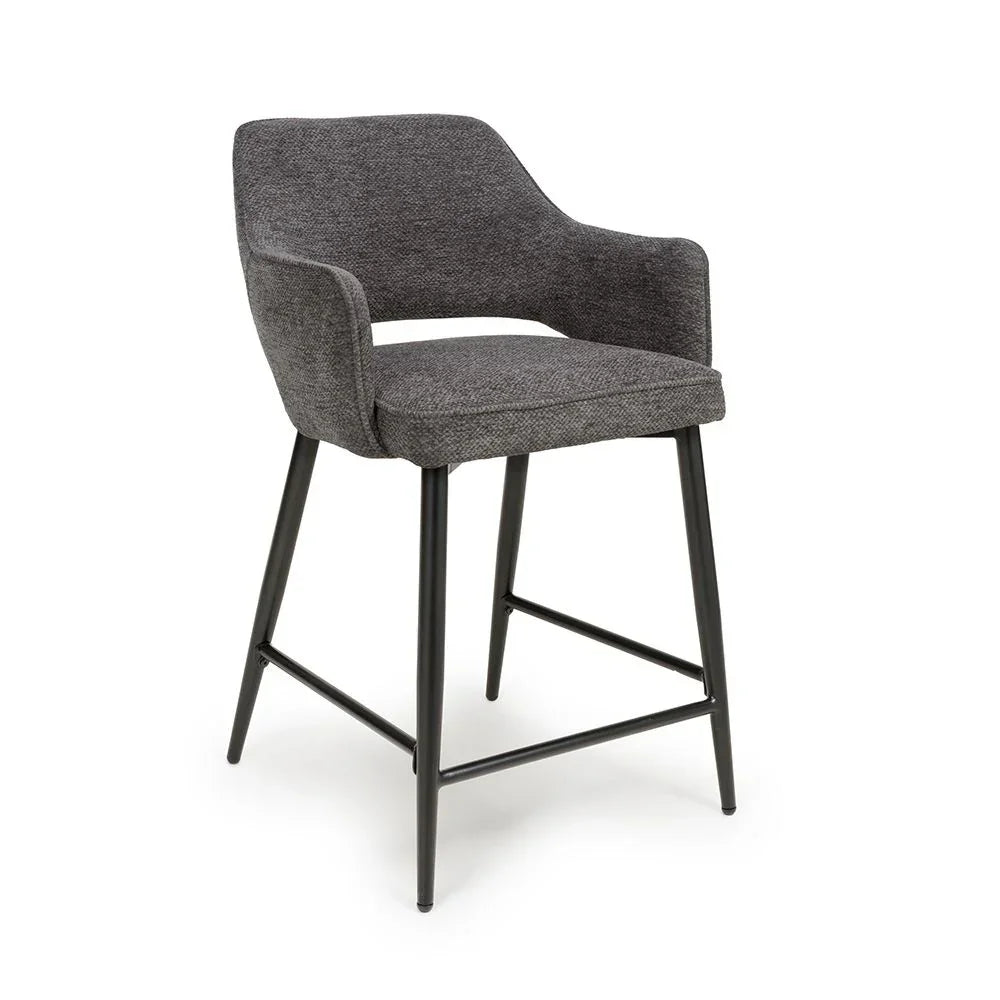 Grey upholstered bar stool with metal legs and armrests on white background