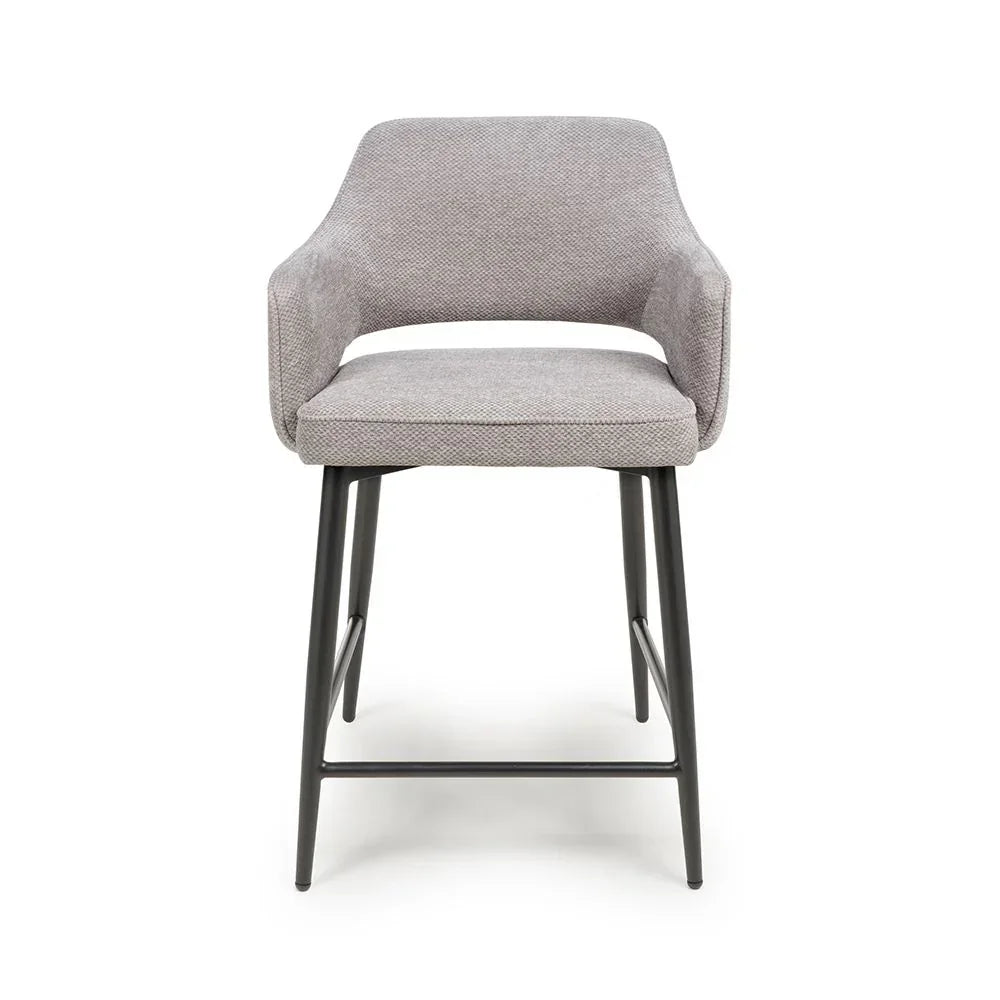 Grey fabric bar stool with curved backrest and black metal legs, front view
