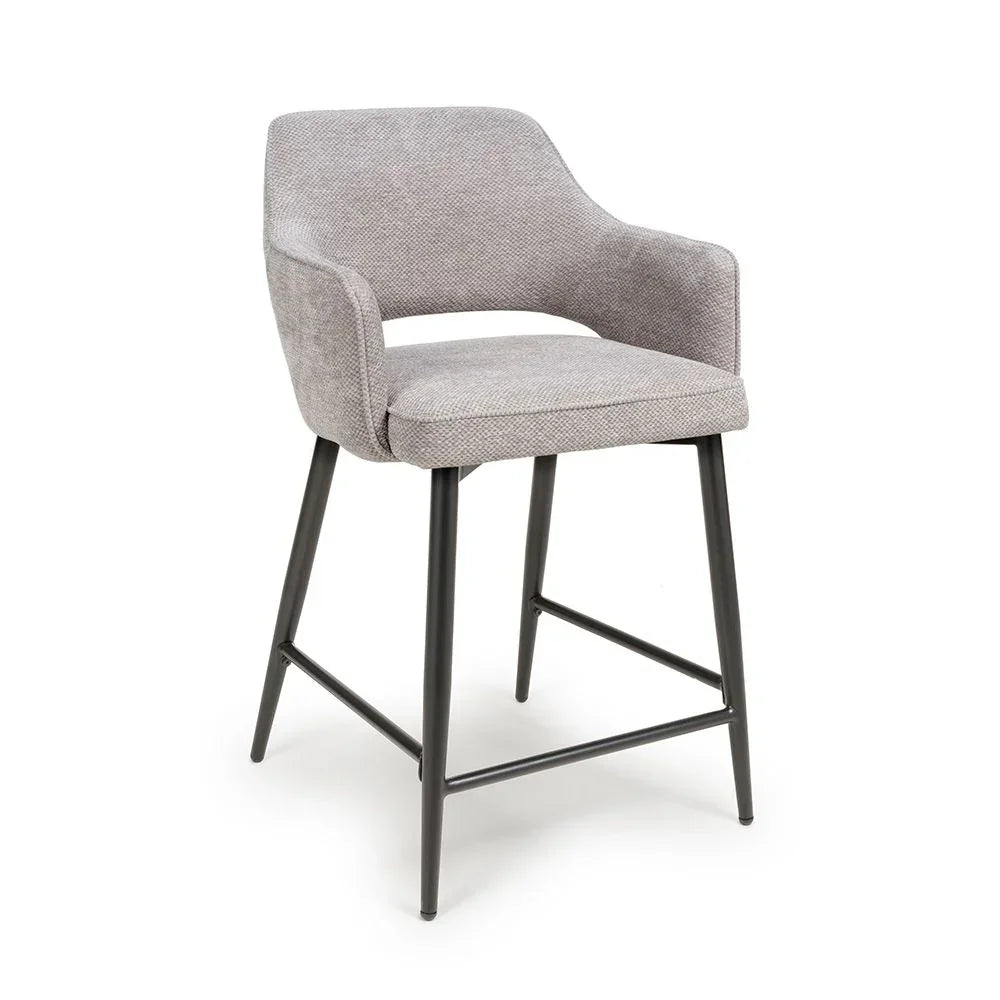 Light grey fabric barstool with metal legs and curved backrest on white background