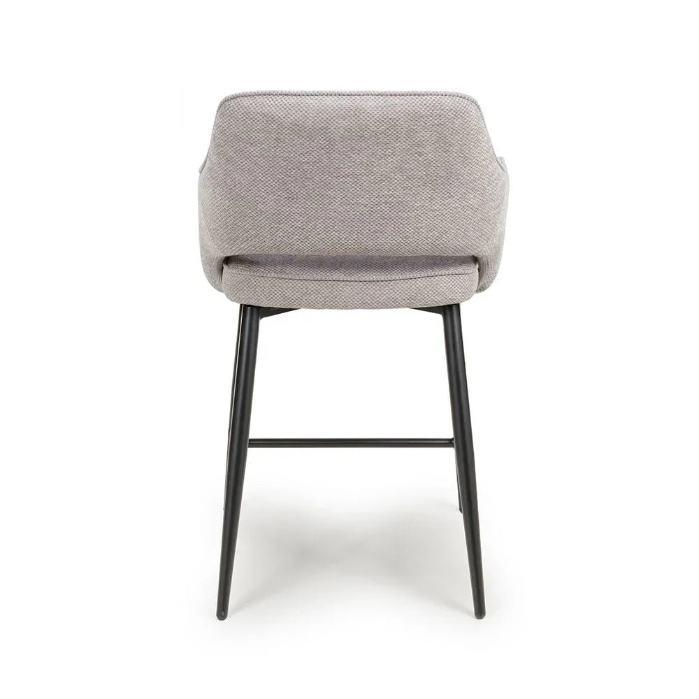 Light grey fabric dining chair with black metal legs, rear view