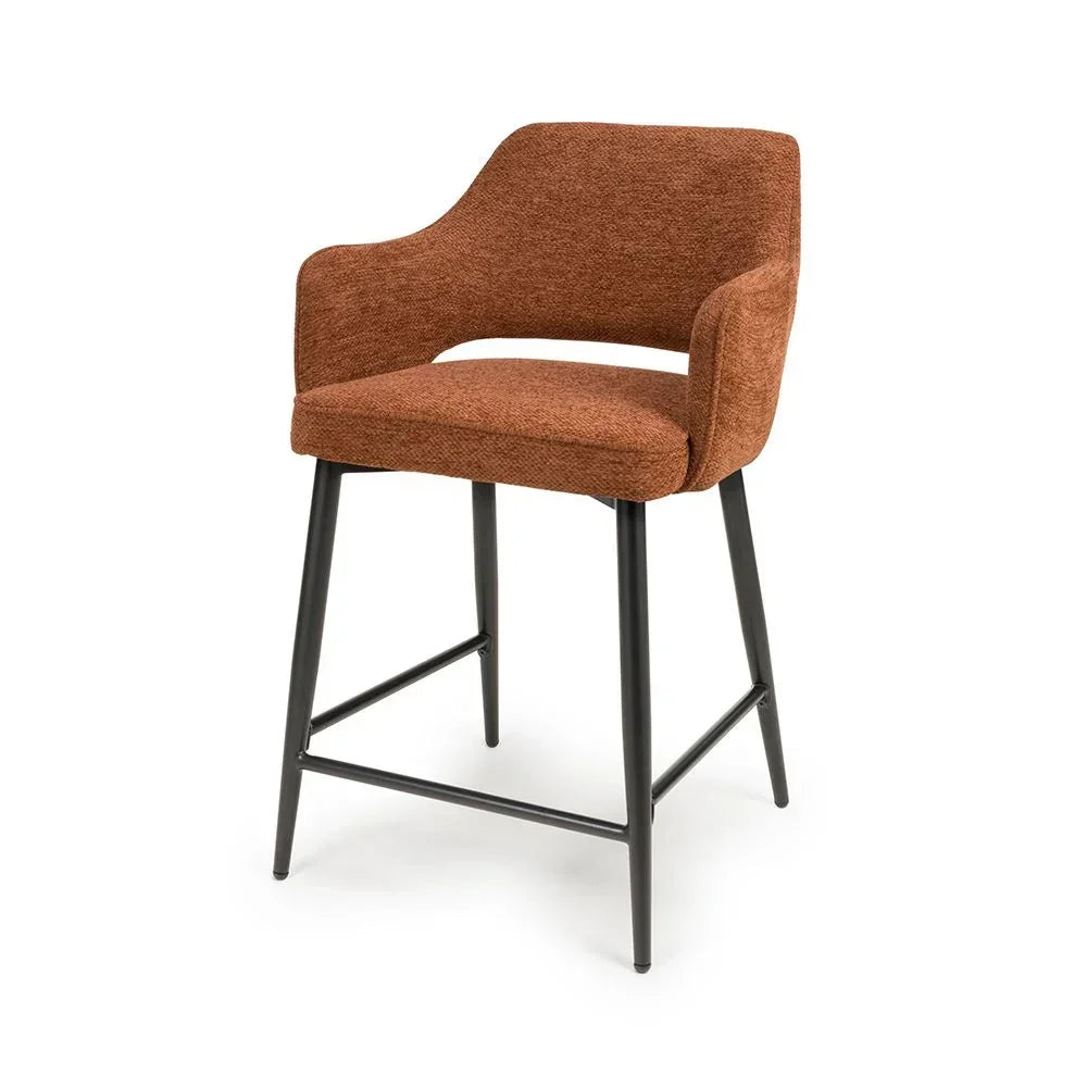 Rust fabric bar stool with curved backrest and black metal legs