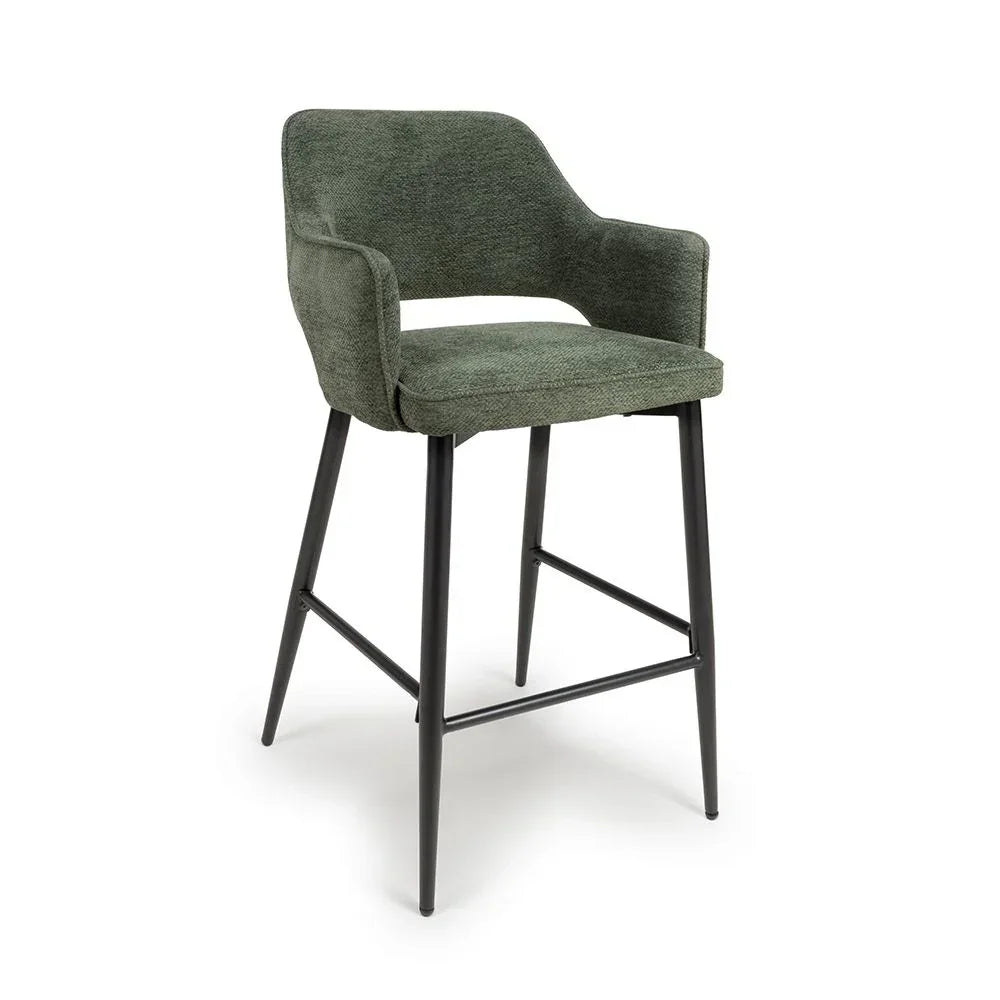 Green fabric bar stool with curved backrest, armrests and black metal legs