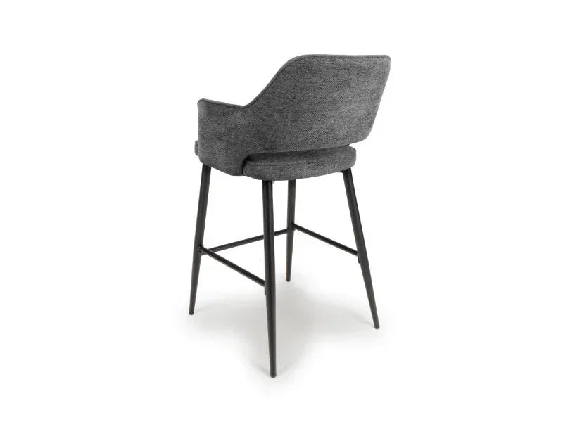 Grey fabric bar stool with curved backrest and black metal legs, rear angle view