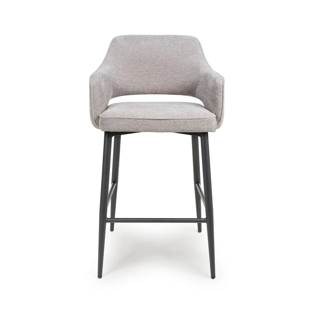 Grey fabric bar stool with curved backrest and black metal legs, front view