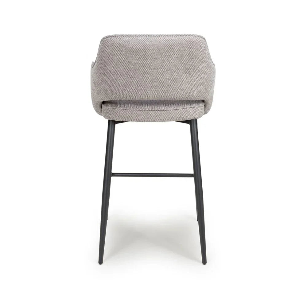 Grey fabric bar stool with black metal legs, rear view