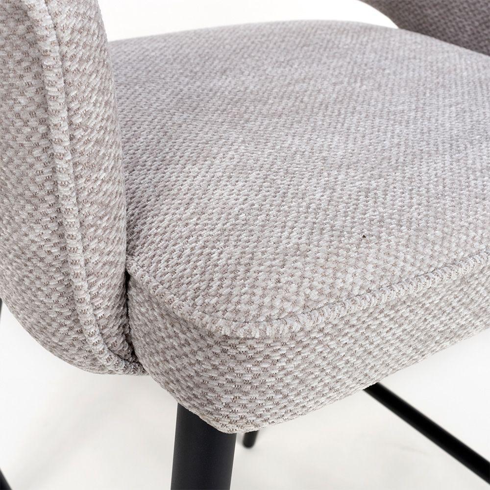 Close-up of grey fabric dining chair seat with black metal legs