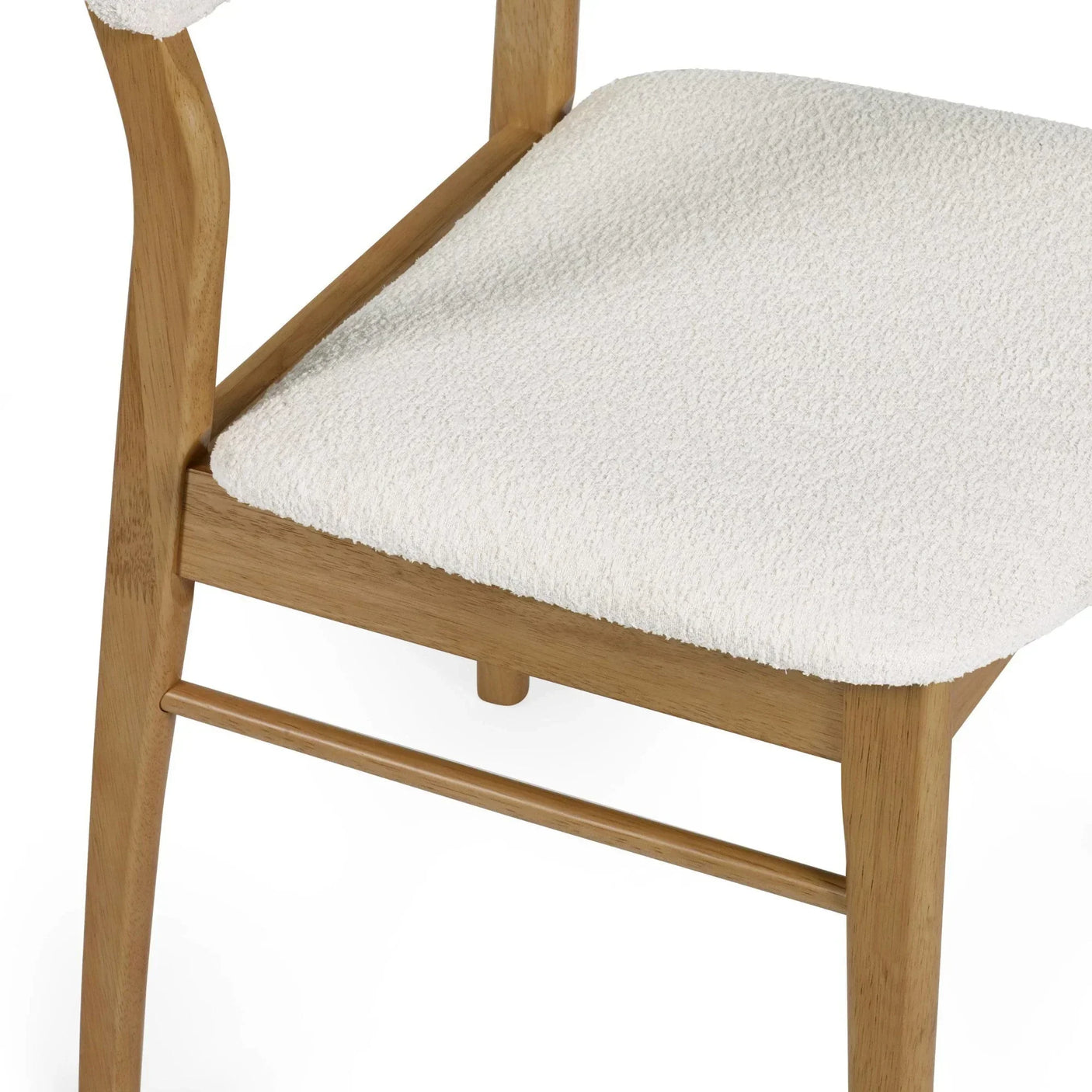 Close view of wooden dining chair with textured cream upholstery on seat