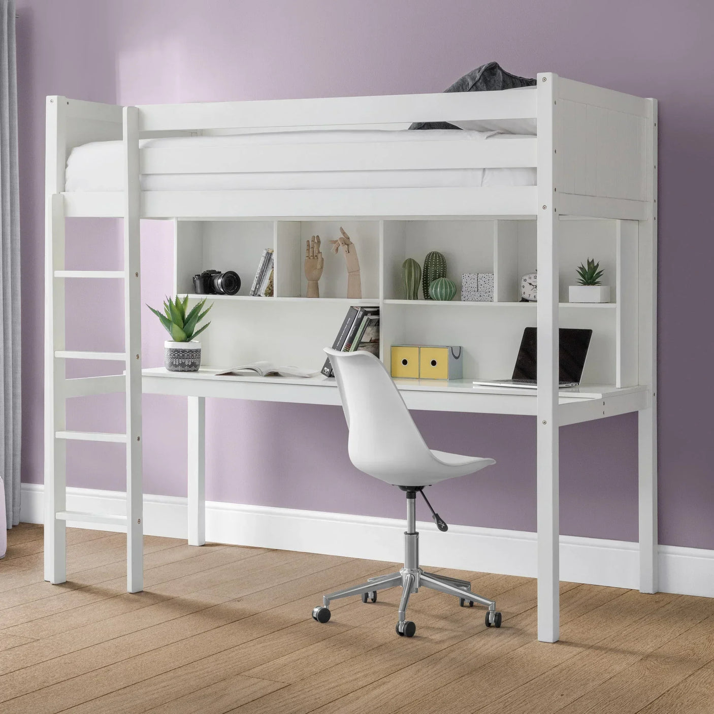 White wooden loft bed with integrated desk, storage shelves, and chair against lavender wall