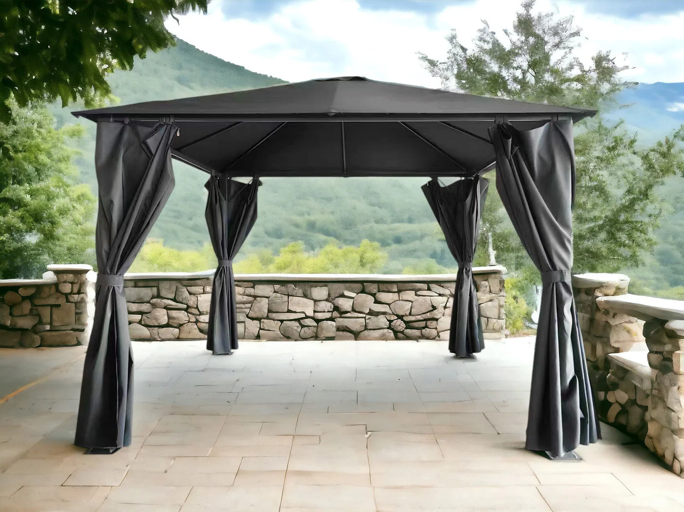 Grey outdoor gazebo with metal frame and curtains on stone patio with mountain view