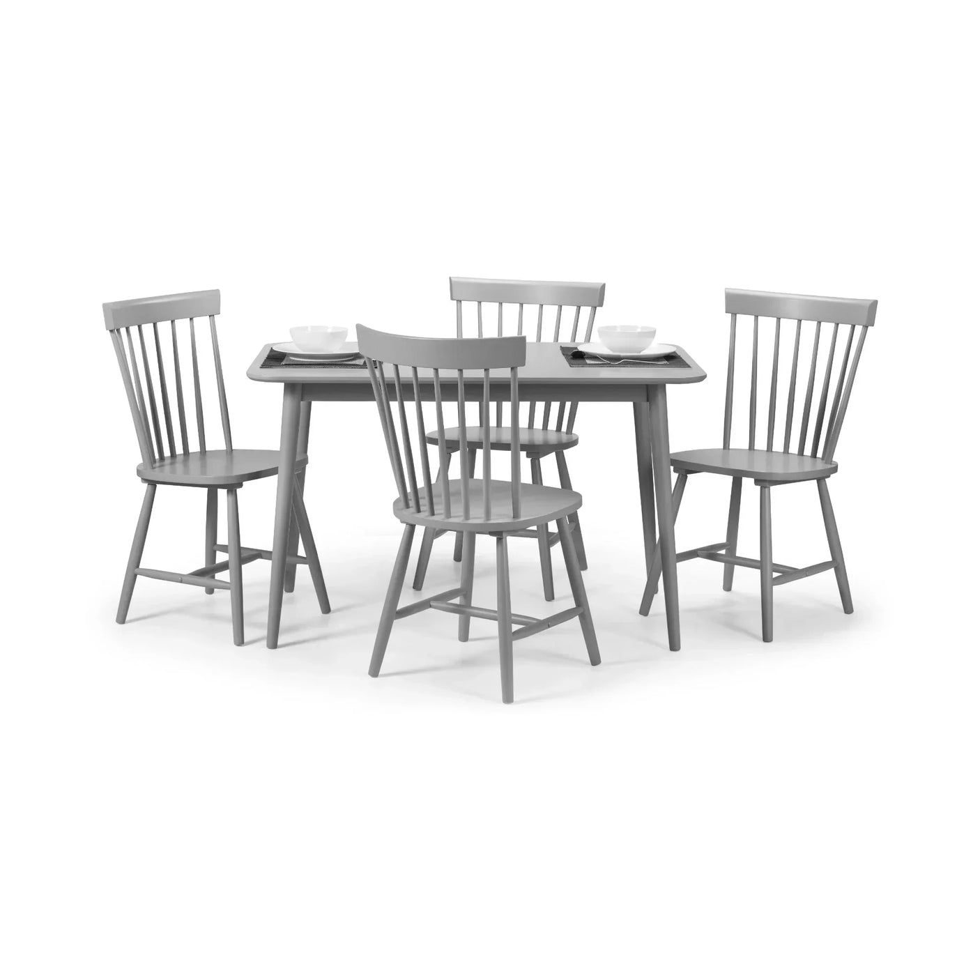 Grey dining table set with four matching wooden chairs and simple place settings