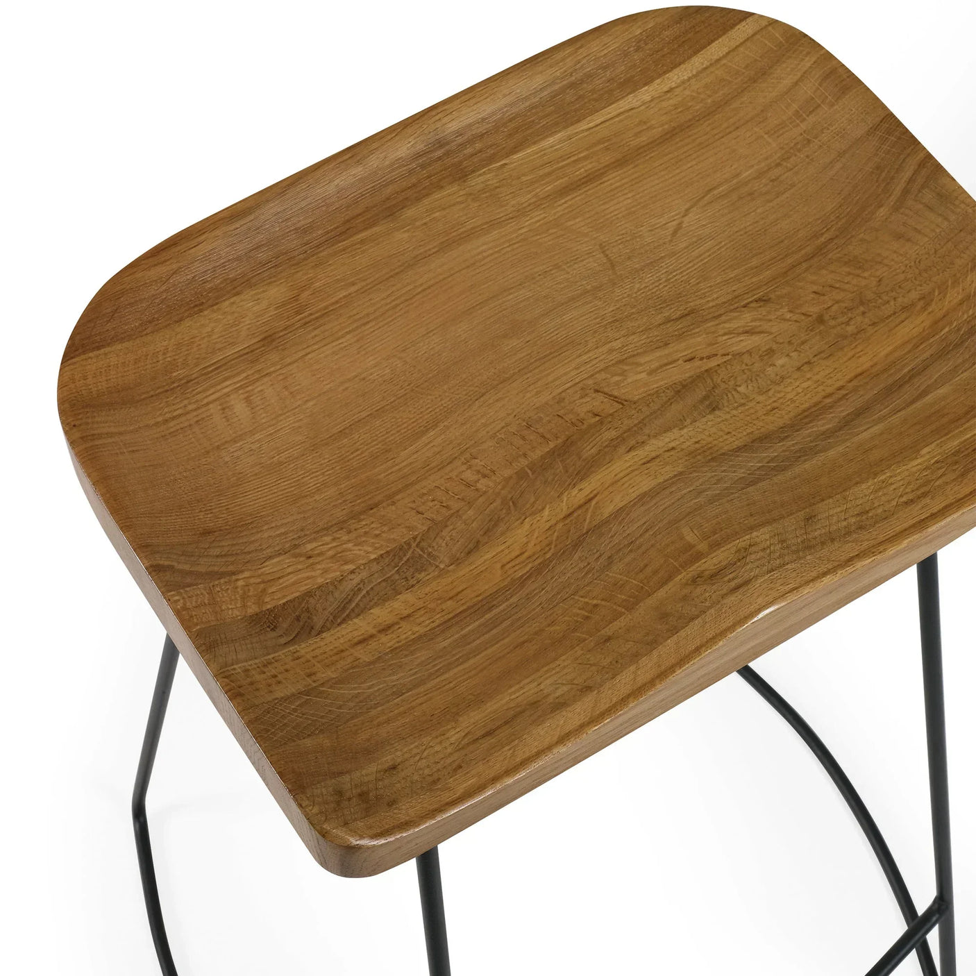 Solid oak bar stool seat close-up with natural wood grain and black metal frame