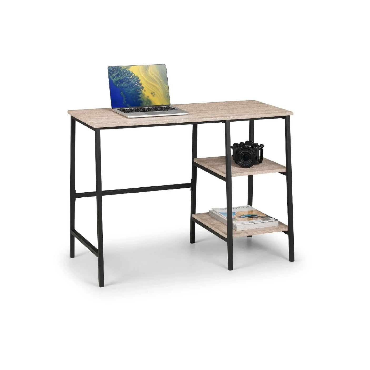 Sonoma oak computer desk with black frame, open shelving, laptop, camera, and magazines
