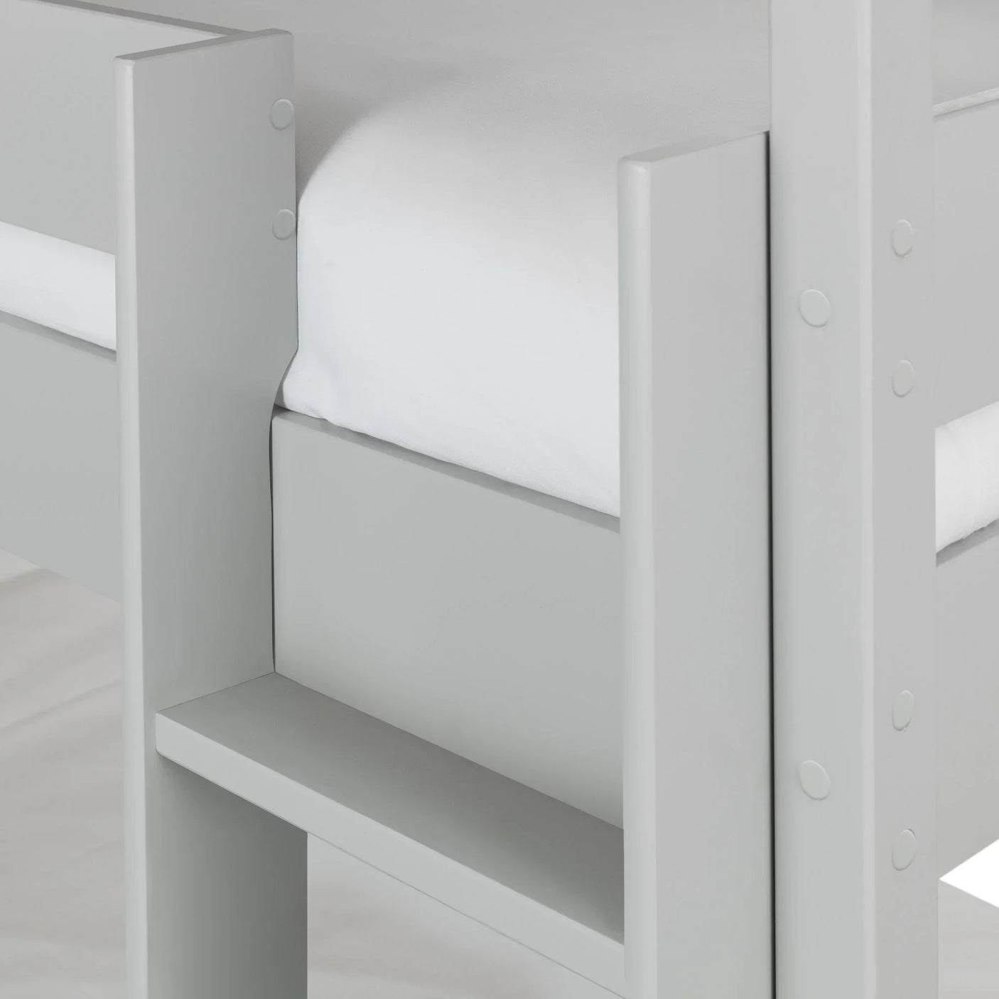 Close up of grey wooden bunk bed frame with guard rail and ladder detail