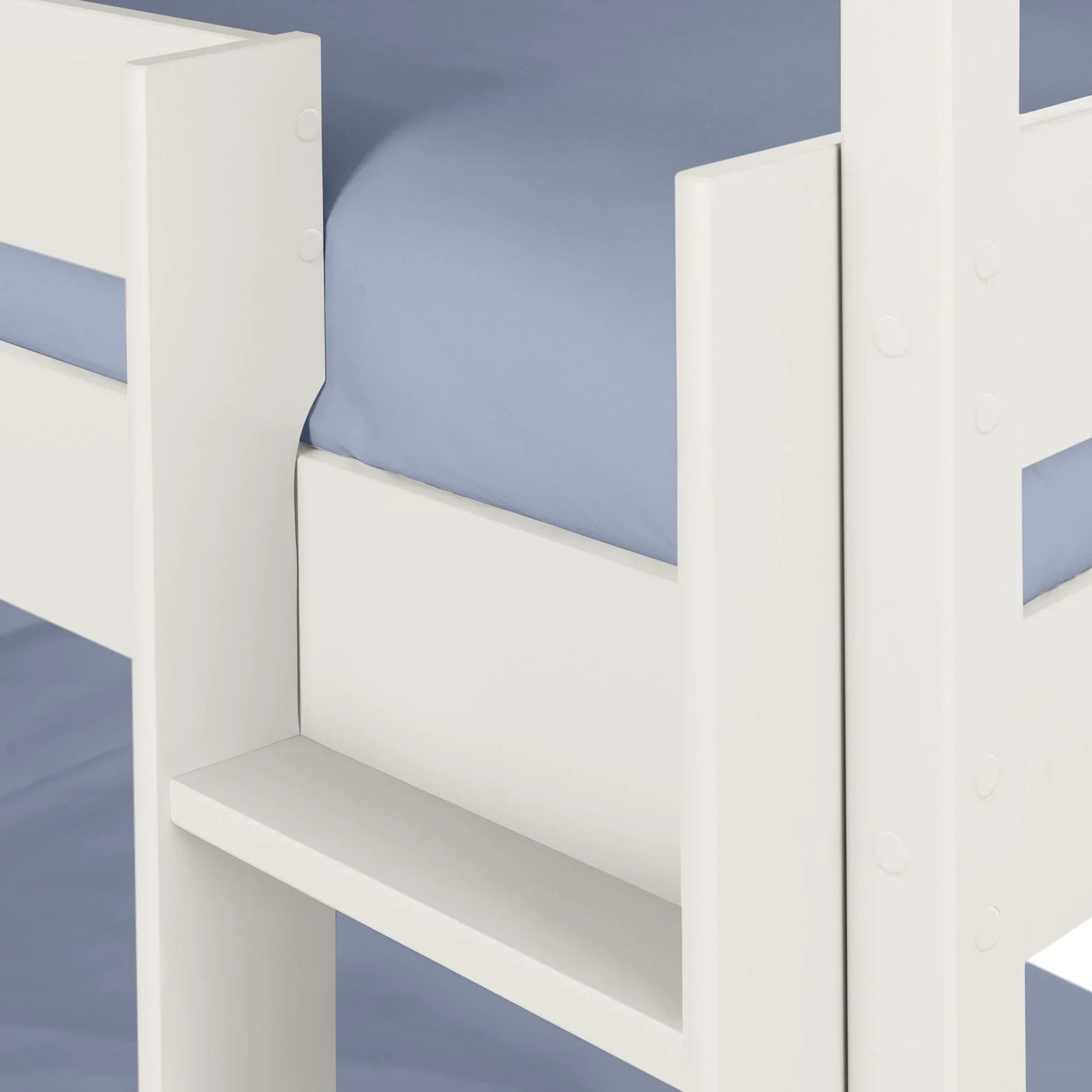 White wooden bunk bed frame with blue mattress and built-in shelf detail