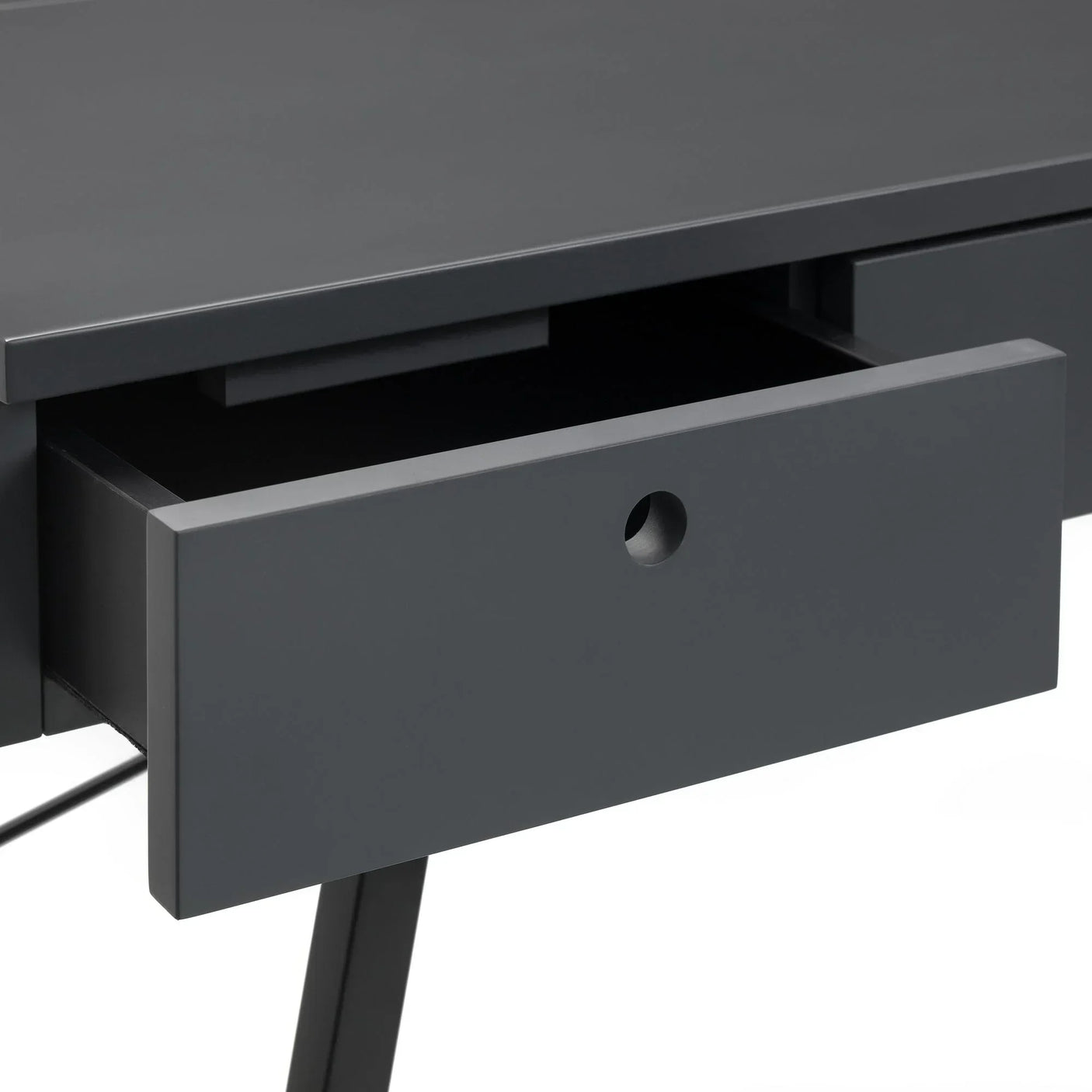 Grey desk with open drawer, matte finish and minimalist design detail